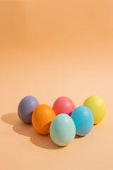 Vertical image of multi colored Easter eggs on a light background, Easter celebration concept