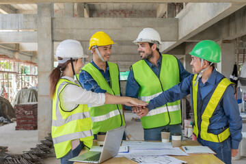 engineer project manager,teamwork meeting on construction site to implement plan of a new building,doing hands stack together for successful business cooperation
