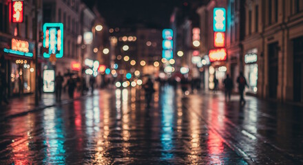 Obraz premium A bustling city street at night with colorful lights and reflections on wet pavement.