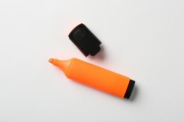 Bright highlighter and cap on white background, flat lay