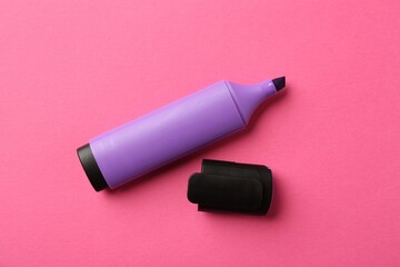 Bright highlighter and cap on pink background, flat lay