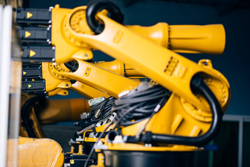 Industrial robotic arms in a high-tech factory, showcasing modern automation and precision engineering. Advanced machinery revolutionizing manufacturing and production.