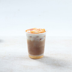 Iced caramel macchiato, A refreshing cold coffee beverage features layers of caramel and whipped...