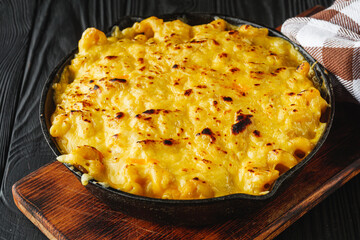 creamy macaroni and cheese on a black wooden rustic background