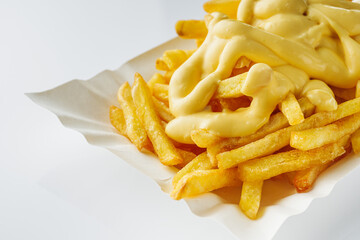 delicious crispy golden french fries with cheese on a white background