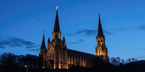 Obraz premium Nighttime view of illuminated Rosary Basilica in Lourdes, showing impressive architectural details under a dark blue sky filled with stars, landmark, sky