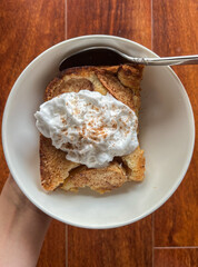 Healthy organic homemade baked apple crumble with vegan coconut whipped cream