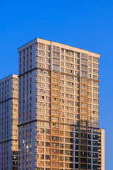City view on a sunny day. Modern buildings, walls and windows. 