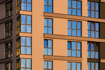 City view on a sunny day. Modern buildings, walls and windows. 