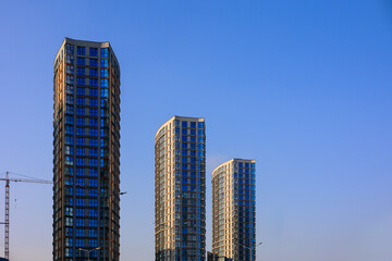 Fototapeta premium City view, modern buildings and skyscrapers against the blue sky.