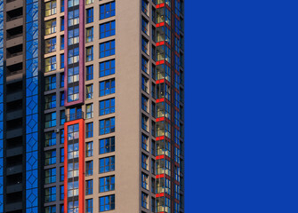 City view on a sunny day. Modern buildings, walls and windows. 