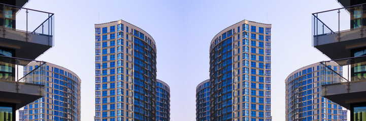 Obraz premium City view on a sunny day. Modern buildings, walls and windows. 