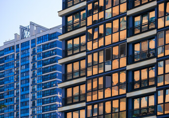 City view on a sunny day. Modern buildings, walls and windows. 
