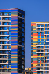 City view on a sunny day. Modern buildings, walls and windows. 