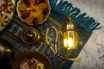 Iftar fast-breaking evening meal of Muslims in Ramadan at the time of adhan. Arabic lantern for...