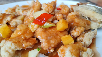 Ikan gurame goreng asam manis, fried gourami fish with sour and sweet sauce. Indonesia food.