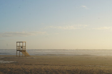 Ocean with Wooden Lifeguard tower during the sunset 