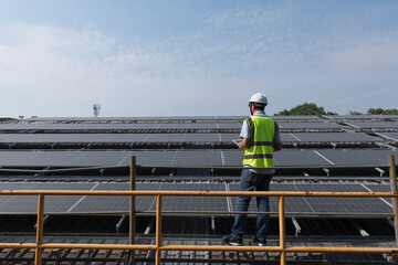 Naklejka premium portrait of a worker on solar cell and sustainable green energy.