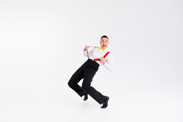 Full body portrait of funny elegant young man pull suspenders dance isolated on white color...
