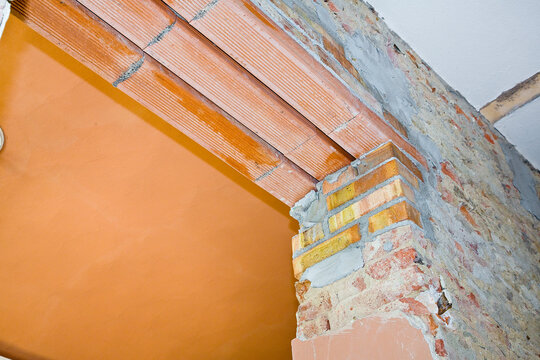New reinforced brick lintel useful for creating a new door, or a new window, in an old stone and brick wall in a construction site