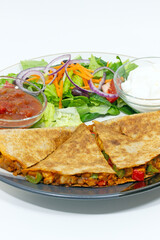 Quesadilla, Mediterranean salad, salsa and sour cream Mexican style food plate