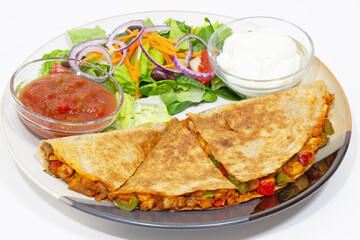 Quesadilla, Mediterranean salad, salsa and sour cream Mexican style food plate