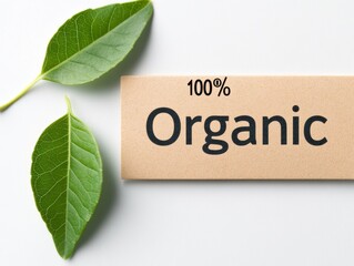 Organic Label with Green Leaves: A close-up shot of a brown label with the inscription "100% Organic" and two fresh green leaves, conveying a message of natural, sustainable, and healthy living. 