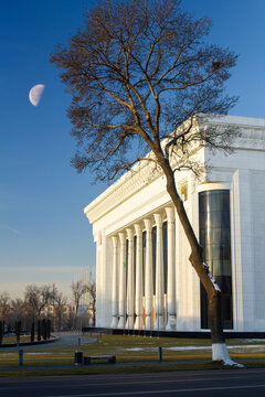 Tashkent Palace of International Forums "Uzbekistan" in Amir Temur Square in the city center. Moon on sky.