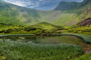 A picturesque lake in a mountain crater in the Carpathians. At an altitude of 700 meters above sea...