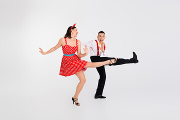 Photo of lovely energetic couple professional dancers moving in dance battle isolated on white...