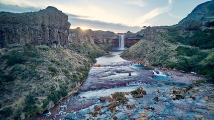 Spectacular view of Salto del Agrio waterfall – a vibrant cascade surrounded by rugged Patagonian landscapes