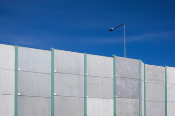 Highway sound barrier and lamppost