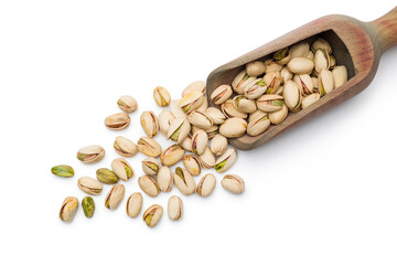 Top view of pistachio nuts scattered with wooden scoop on white background.