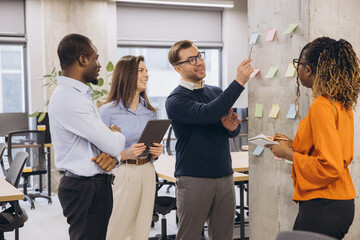 Business colleagues collaborating and sharing ideas during a productive meeting in a contemporary workspace