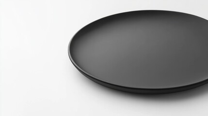 A sleek black ceramic plate with a smooth, matte finish and minimalist design, isolated on a white background.