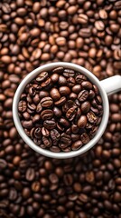 Fototapeta premium A cup of coffee sits atop a large pile of whole coffee beans 