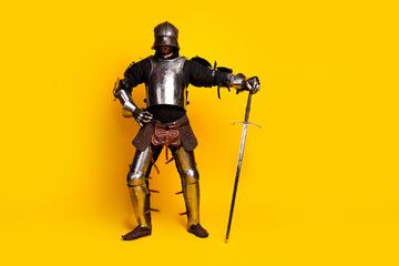 Portrait of a Knight in Armor With a Sword on a Vibrant Yellow Background