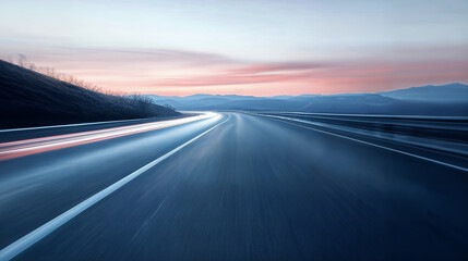 A Highway Stretching into the Misty Mountains at Sunrise showing motion blue speed