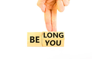 Belonging and belong symbol. Concept words Be you Belong on beautiful wooden block. Beautiful white background Businessman hand. Business motivational belonging and belong concept. Copy space.