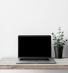 Fototapeta premium Laptop mockup on a wooden table with a plant, against a white background, in a minimalist style, studio photography, stock photo.