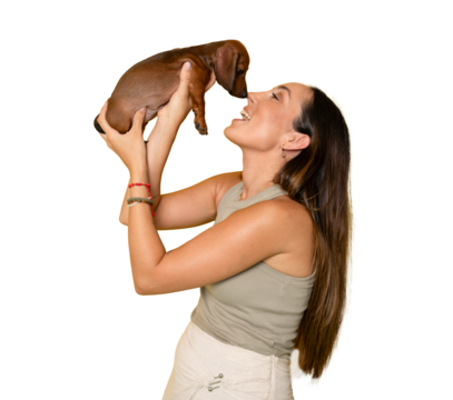 Cute young woman kisses and hugs her puppy dachshund dog. Love between owner and dog. Isolated on transparent background. Studio portrait. PNG transparent.