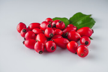 fresh red rose hips on a white background