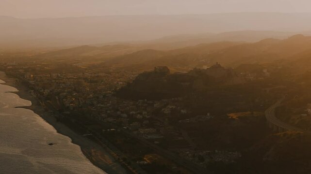 Aerial View of a Castle at  a Southern Coastal Town Roccella Ionica at Sunset