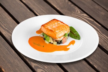 Fried tasty fish steak with cooked vegetables
