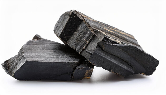 black pieces of mumiyo or shuddha shilajit isolated on white background
