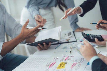 Strategic Collaboration:  A team of professionals meticulously analyzes data and financial reports,...