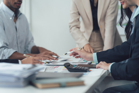 Strategic Brainstorming: A close-up shot of a diverse group of professionals engaged in a collaborative brainstorming session around a conference table.