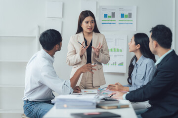 Business Meeting Collaboration: A confident female leader passionately presents ideas to her diverse team during a productive meeting, fostering collaboration and insightful discussions.  