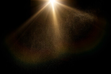 Dust particles shimmer in a radiant sunbeam against a dark background, creating a mystical god rays...