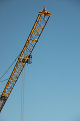  Construction Yellow crane against blue sky